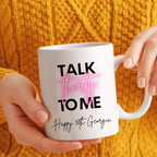 White mug with 'Talk thirty to me' text held by a person against an orange textured background