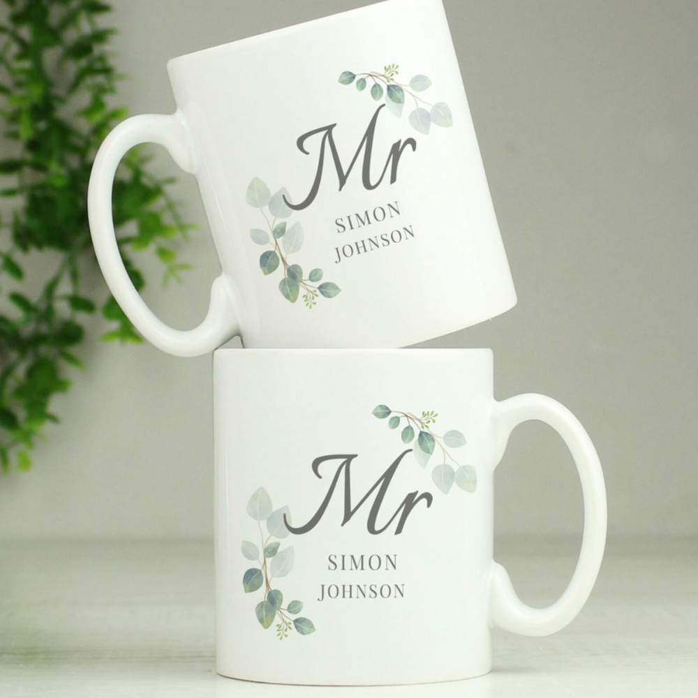 Two white mugs with 'Mr' and personalized names on a light background