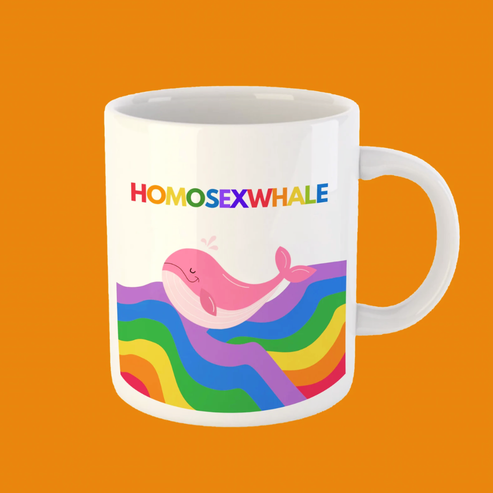 Mug with a pink whale and rainbow design on an orange background