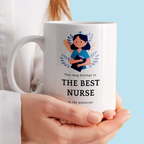 White mug with a design of a nurse and text held by a person against a light blue background