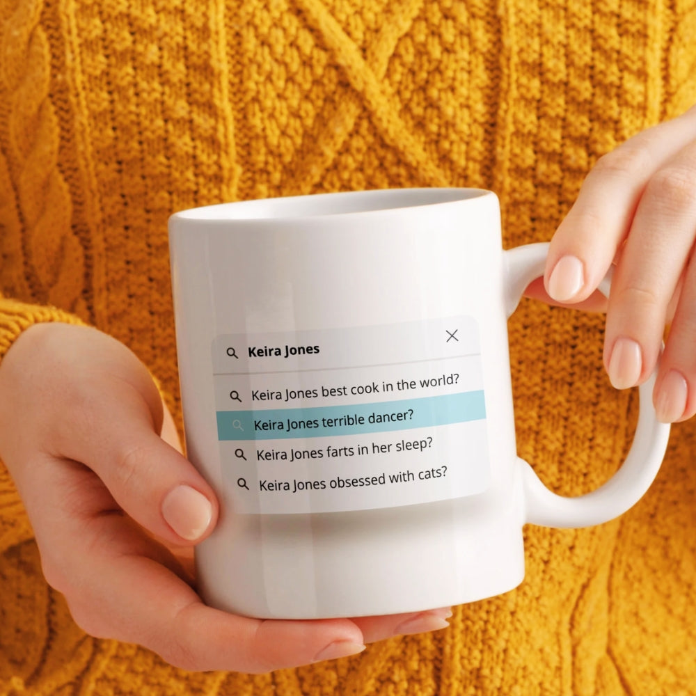 Person holding a white mug with text about Keira Jones on an orange background