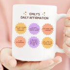 Mug with 'Emily's Daily Affirmation' text and colorful affirmations held by a person.