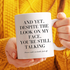 Person holding a mug with text in front of a yellow textured background