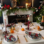 Forest green woodland Christmas crackers styled on a festive dinner table