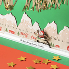 Close-up of the movable Santa and reindeer on a wooden Christmas countdown