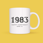 White mug with '1983 Happy Birthday Dad X' text on a yellow background
