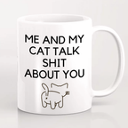 White mug with black text and a cat illustration on a white background