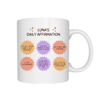 White mug with colorful daily affirmation text on a white background
