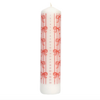 A white advent candle with red vertical stripes, red bows, and numbered days from 1 to 24 printed vertically, shown on a plain white background.
