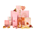 A pink gourmet gift hamper set against a white background, featuring a pink box from Ambers 1926, a bottle of Bottega rose sparkling wine, a flute of pink liquid, assorted pink and yellow sweets, cookies, and packaged treats including Le Pizuzzi and Cheese Sables.