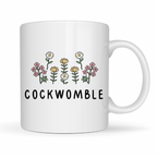 White mug with floral design and 'COCKWOMBLE' text on a white background