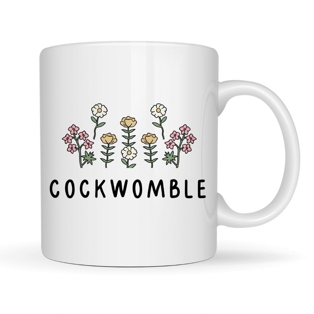 White mug with floral design and 'COCKWOMBLE' text on a white background