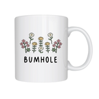 White mug with floral designs and the word 'BUMHOLE' on a white background