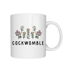 White mug with floral design and 'COCKWOMBLE' text on a white background