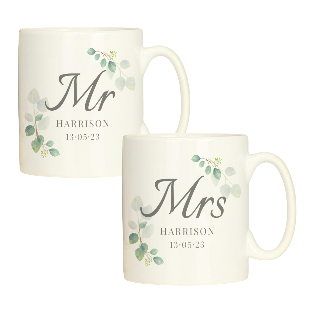 Two white mugs with 'Mr' and 'Mrs' text and decorative elements on a white background