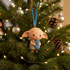 Personalised Dobby decoration hanging on a lit Christmas tree with baubles and pine cones
