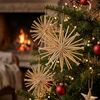 Natural wood starburst Christmas tree ornaments hanging on a decorated Christmas tree in a cozy living room with a burning fireplace in the background.
