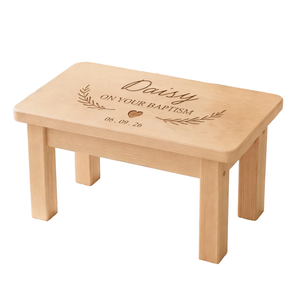 A small wooden children's stool or bench with rounded corners, engraved with the words 'Daisy ON YOUR BAPTISM' and a date, shown in a styled nursery setting on a star-patterned rug.