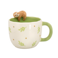 Mug with a sloth figurine on top on a white background