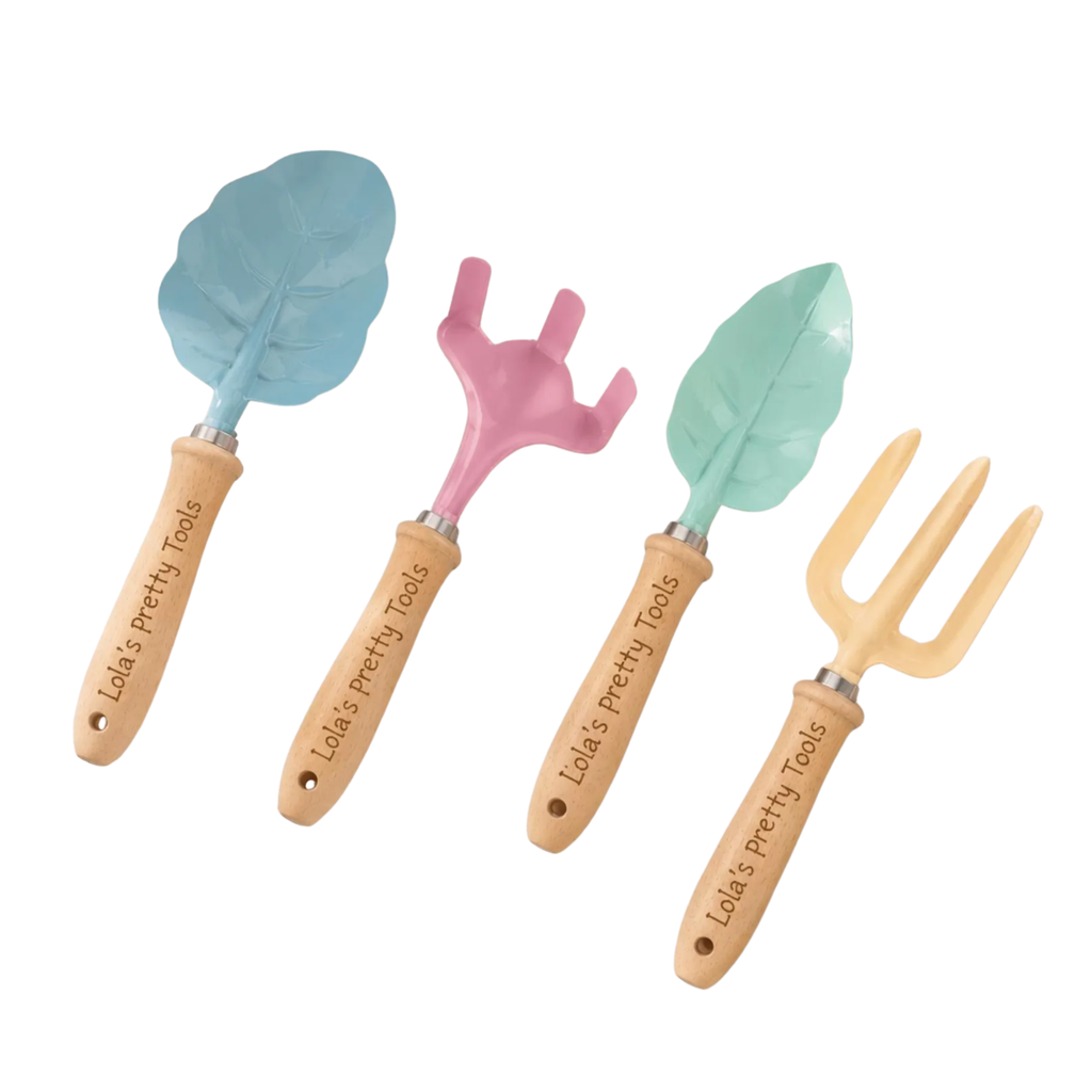 Four wooden-handled gardening tools on a white background: a blue leaf-shaped trowel, a pink leaf-shaped weeder, a mint green leaf-shaped transplanting fork, and a natural wood three-prong garden fork. Each handle is engraved with 'Lola's Pretty Tools'.