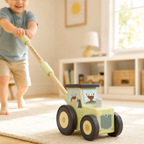 A child pushes a wooden toy tractor on a light rug in a bright, modern room. The toy tractor is light green with black and beige wheels and cartoon animal windows.