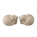 A pair of ceramic cat-shaped salt and pepper shakers in a warm cream color, shown side by side against a plain white background.