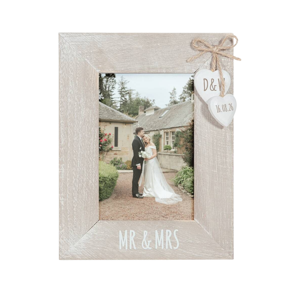A rustic light gray wooden picture frame with 'MR & MRS' printed on the bottom, featuring a personalized heart-shaped tag tied with twine on the top right and a photo of a bride and groom in the center.