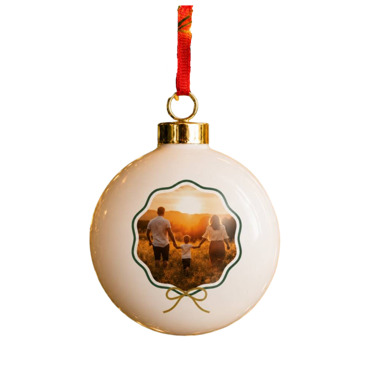 A round white ceramic Christmas ornament featuring a custom printed family photo in the center, hanging from a red ribbon with a gold cap on a white background.