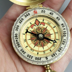 Close-up of a decorative compass held in a hand