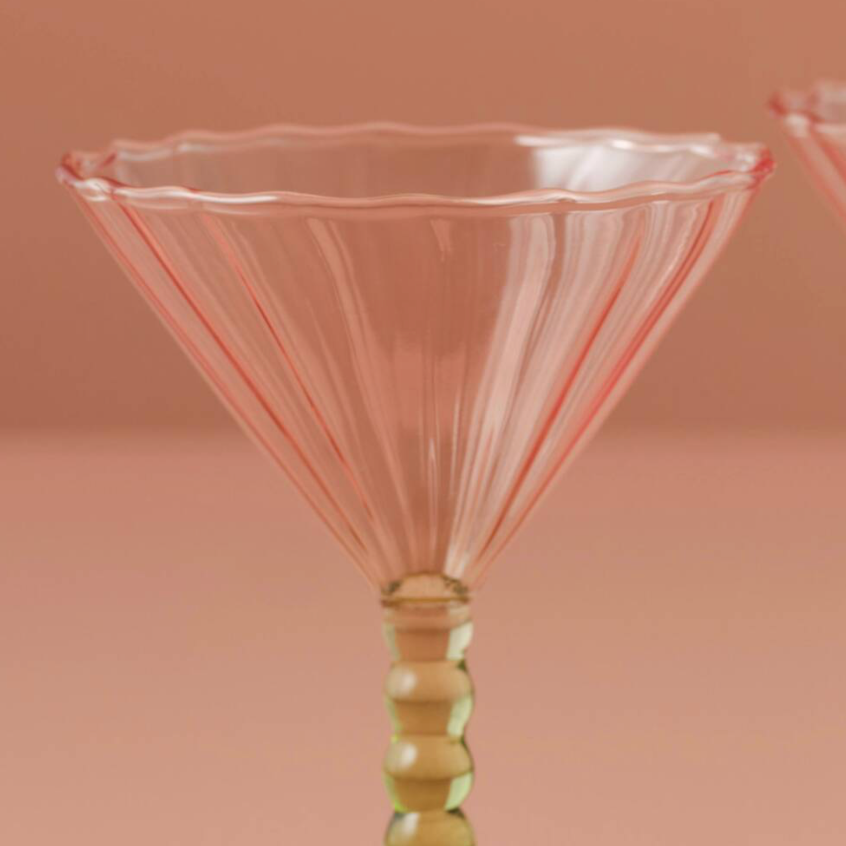A Pair Of Pink And Green Coupe Cocktail Glasses