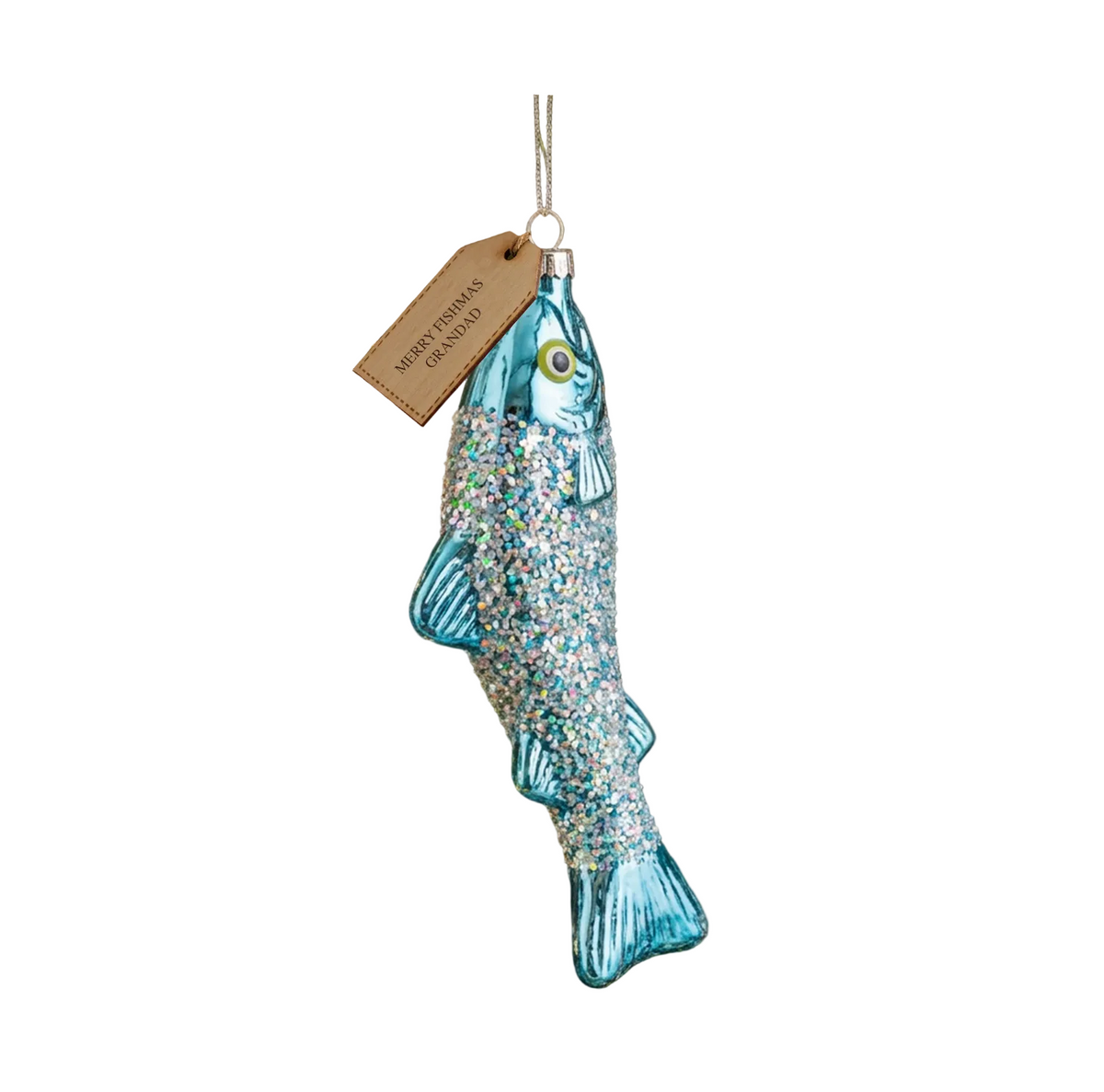 A glittery blue fish-shaped Christmas ornament hanging on a decorated Christmas tree branch, with a small paper tag that reads "SOUTHERN HAWKING.".