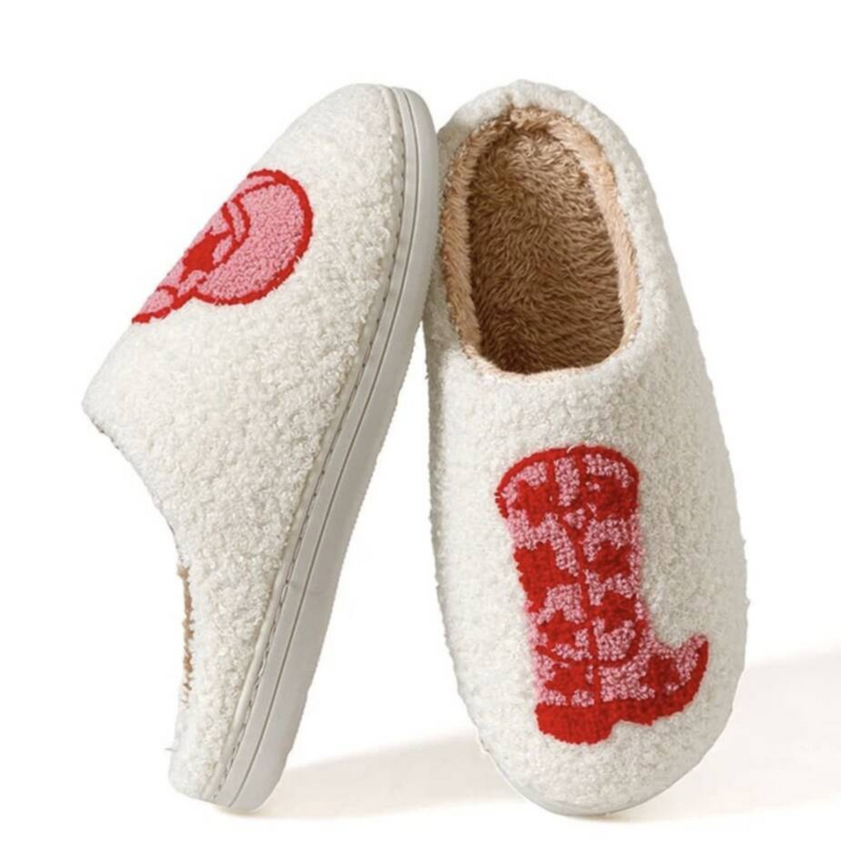 A pair of off-white sherpa slip-on slippers with red embroidered boot motifs on the sides, displayed against a clean white background.