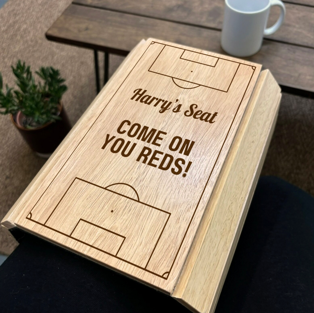 Wooden box with 'Harry's Seat Come On You Reds!' text on a wooden surface.