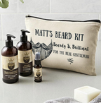 Beard care products including bottles and a pouch labeled 'Matt's Beard Kit' on a bathroom counter.