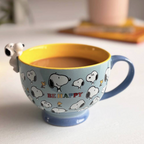 Detail shot of Snoopy Be Happy Cup showing the 3D Snoopy hanging over the yellow interior