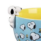 Close up of 3D Snoopy figure perched on the rim of the Be Happy mug