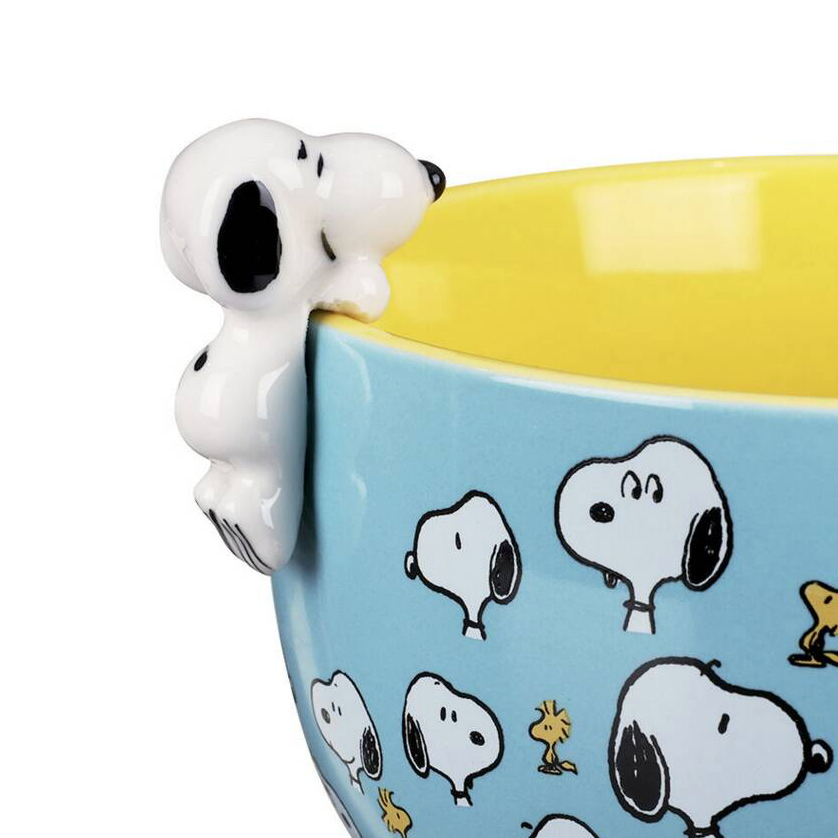 Close up of 3D Snoopy figure perched on the rim of the Be Happy mug