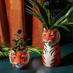Ceramic Tiger Vase with large tropical plant growing from the top, jungle backdrop