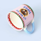 Go Get Em Tiger mug tipped on its side showing the interior and red ric-rac detail
