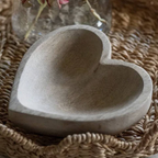 Close up of Mango Wood Heart Shaped Trinket Holder on a white lace surface showing natural wood grain