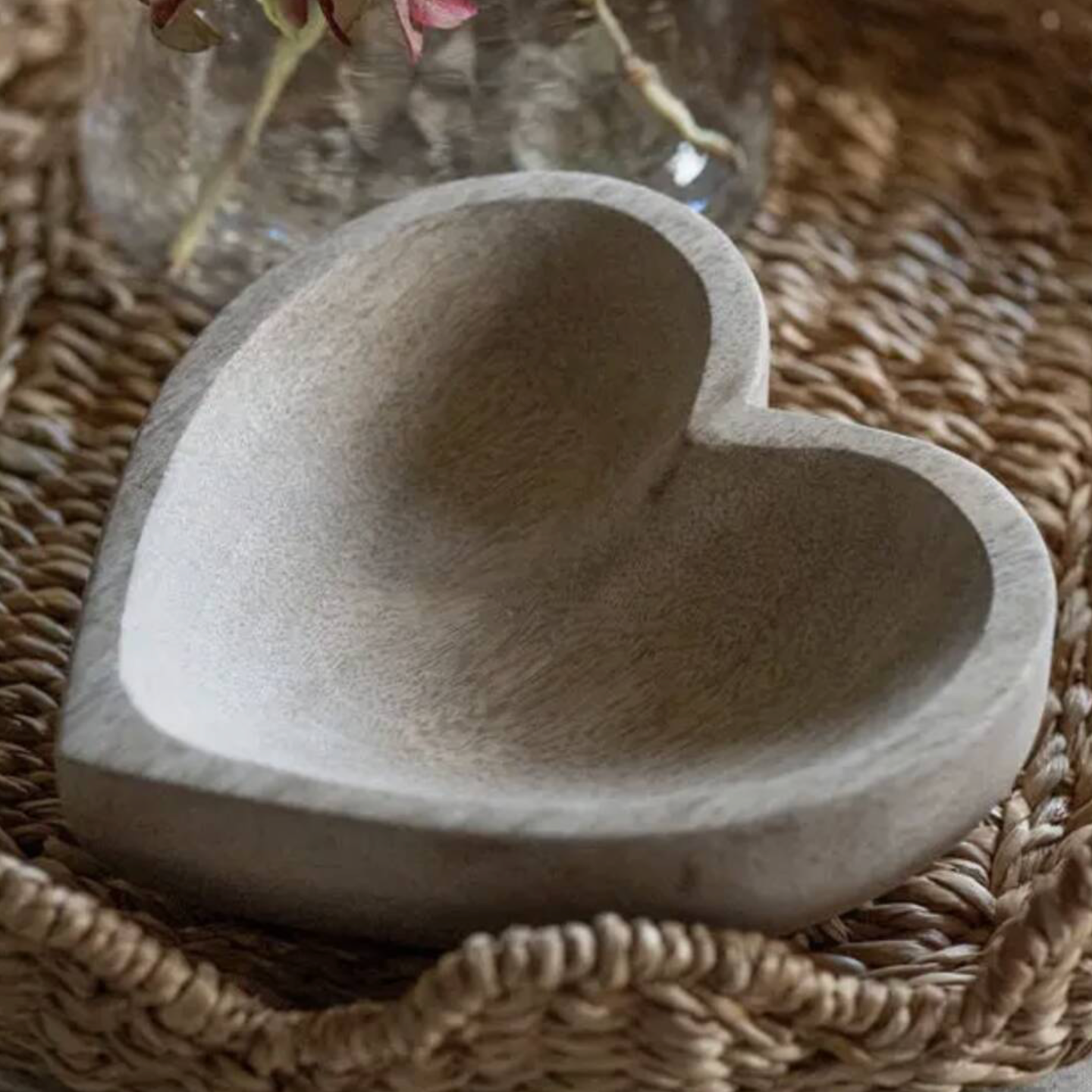 Close up of Mango Wood Heart Shaped Trinket Holder on a white lace surface showing natural wood grain