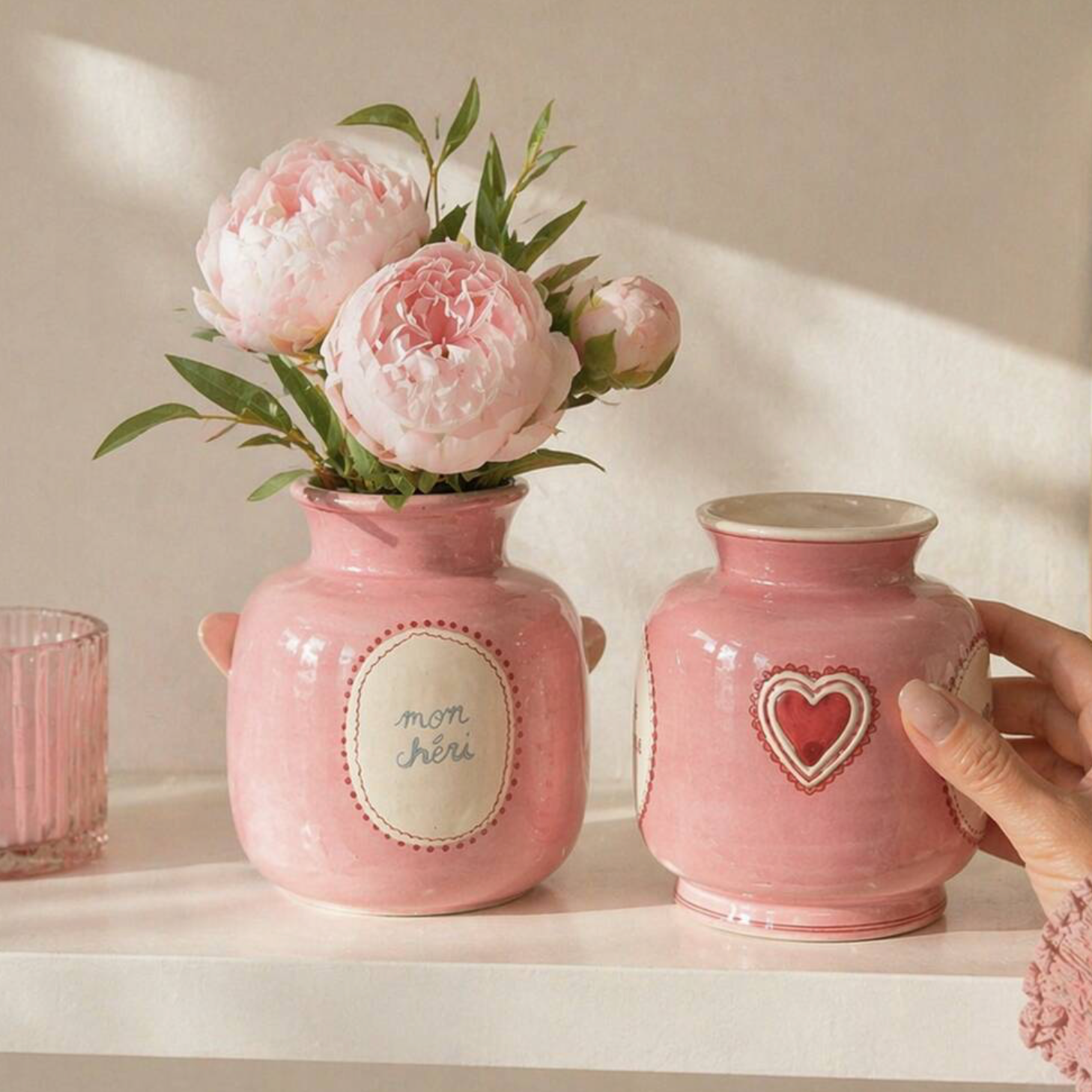 Mini Pink Dopamine Vase held up close showing the mon chéri cartouche with white roses
