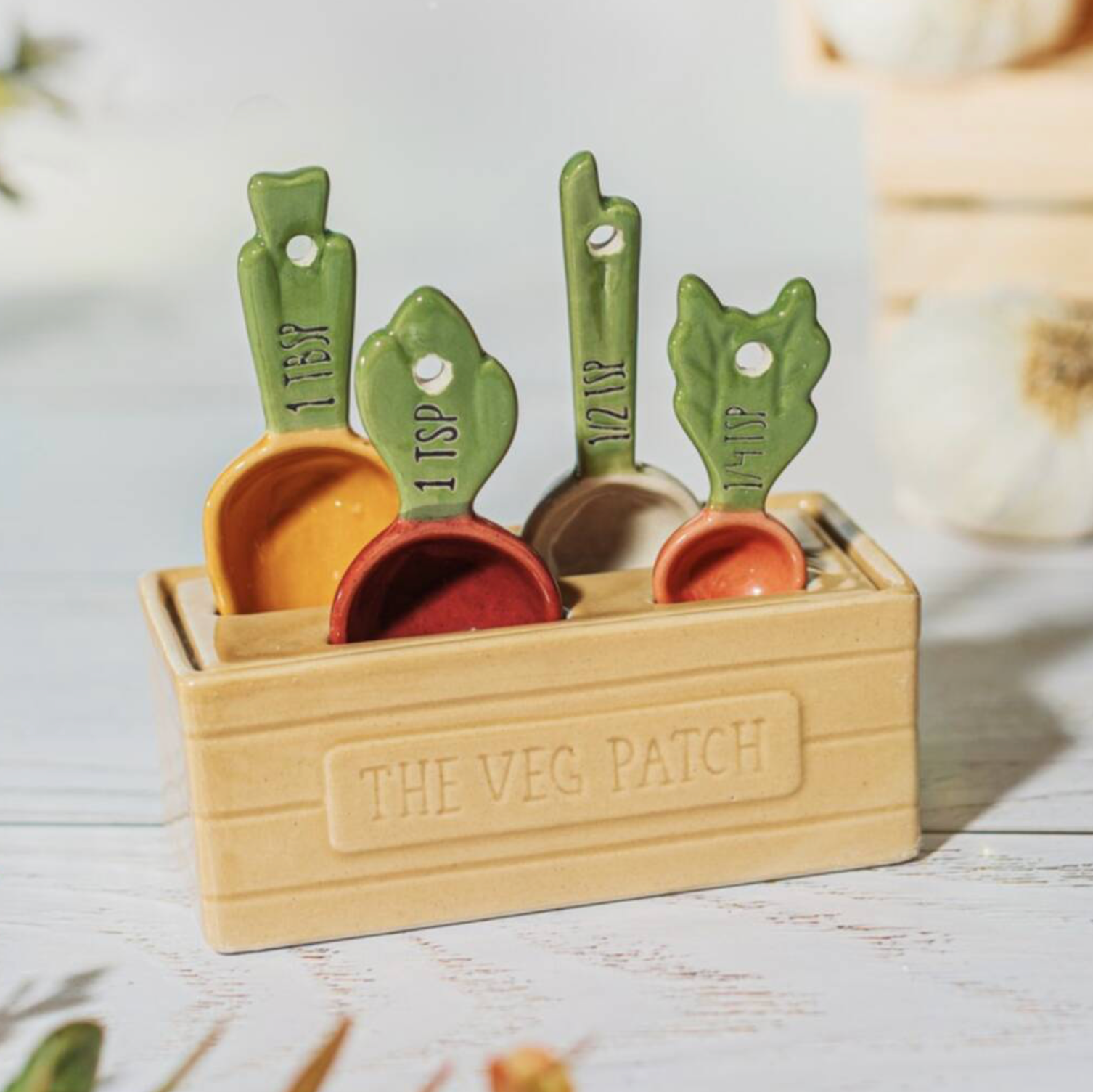 Ceramic Vegetable Patch Measuring Spoons laid out flat on white background showing carrot beetroot garlic and radish designs