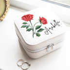 Personalised Birth Flower Jewellery Case with rose June birth flower and name Arabella on white surface with rings