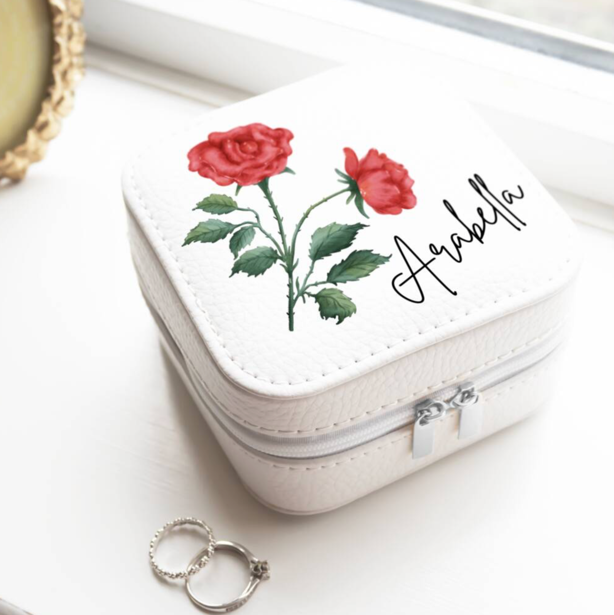 Personalised Birth Flower Jewellery Case with rose June birth flower and name Arabella on white surface with rings