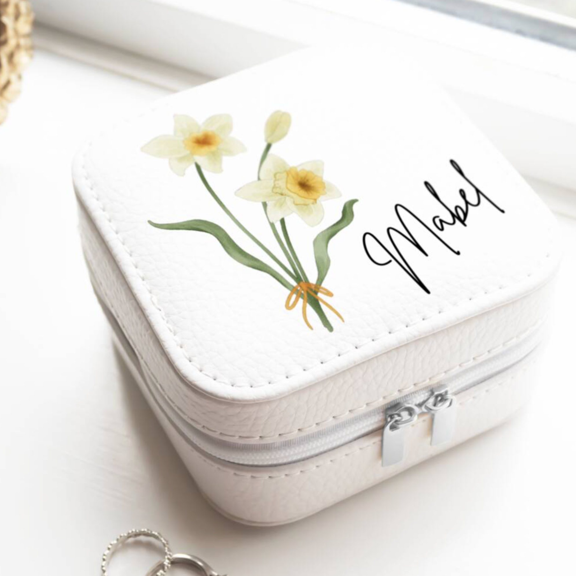 Personalised Birth Flower Jewellery Case with daffodil March birth flower and name Millie held in two hands