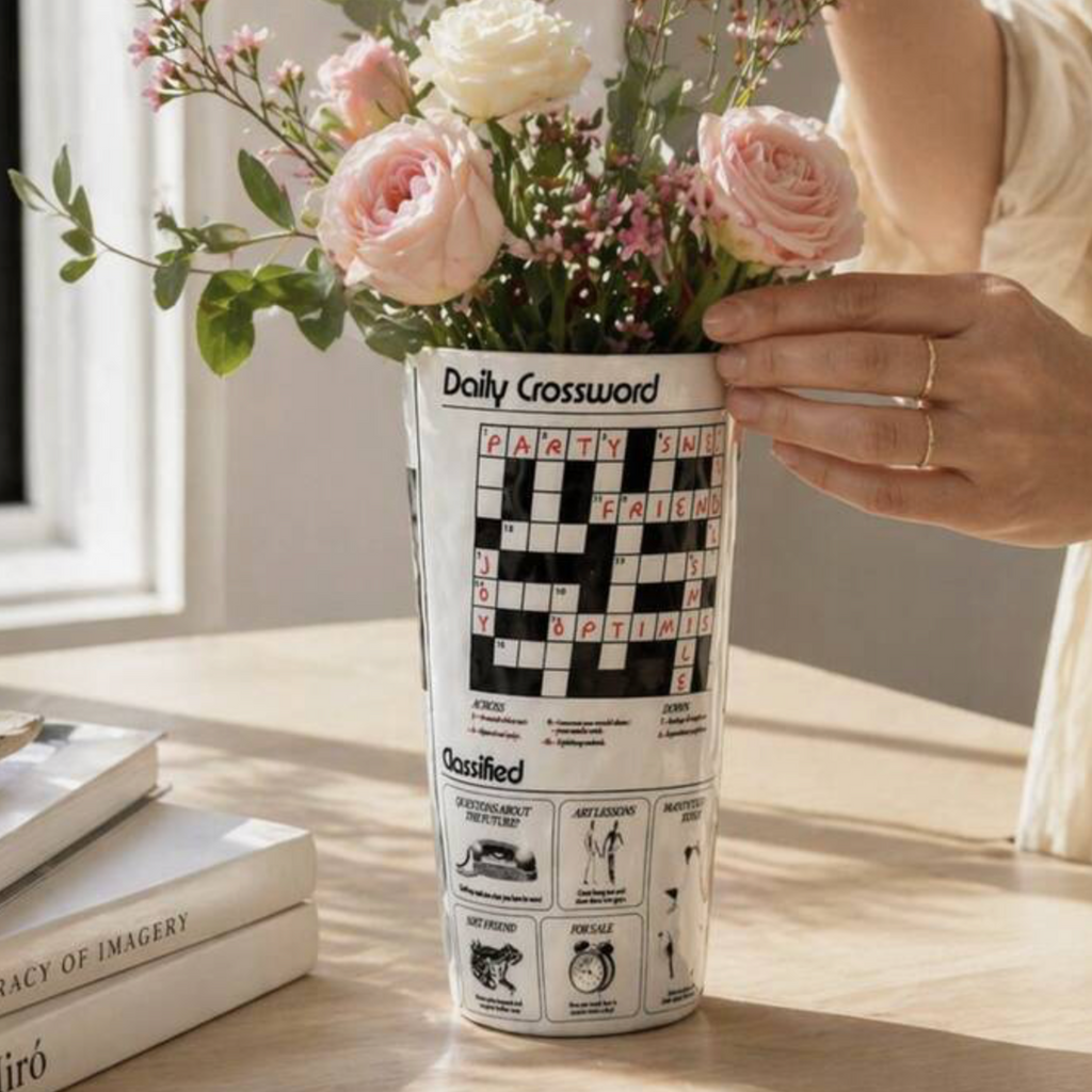 Daily Crossword Ceramic Vase on white background showing the Good News column and crossword print wrapping around the conical form
