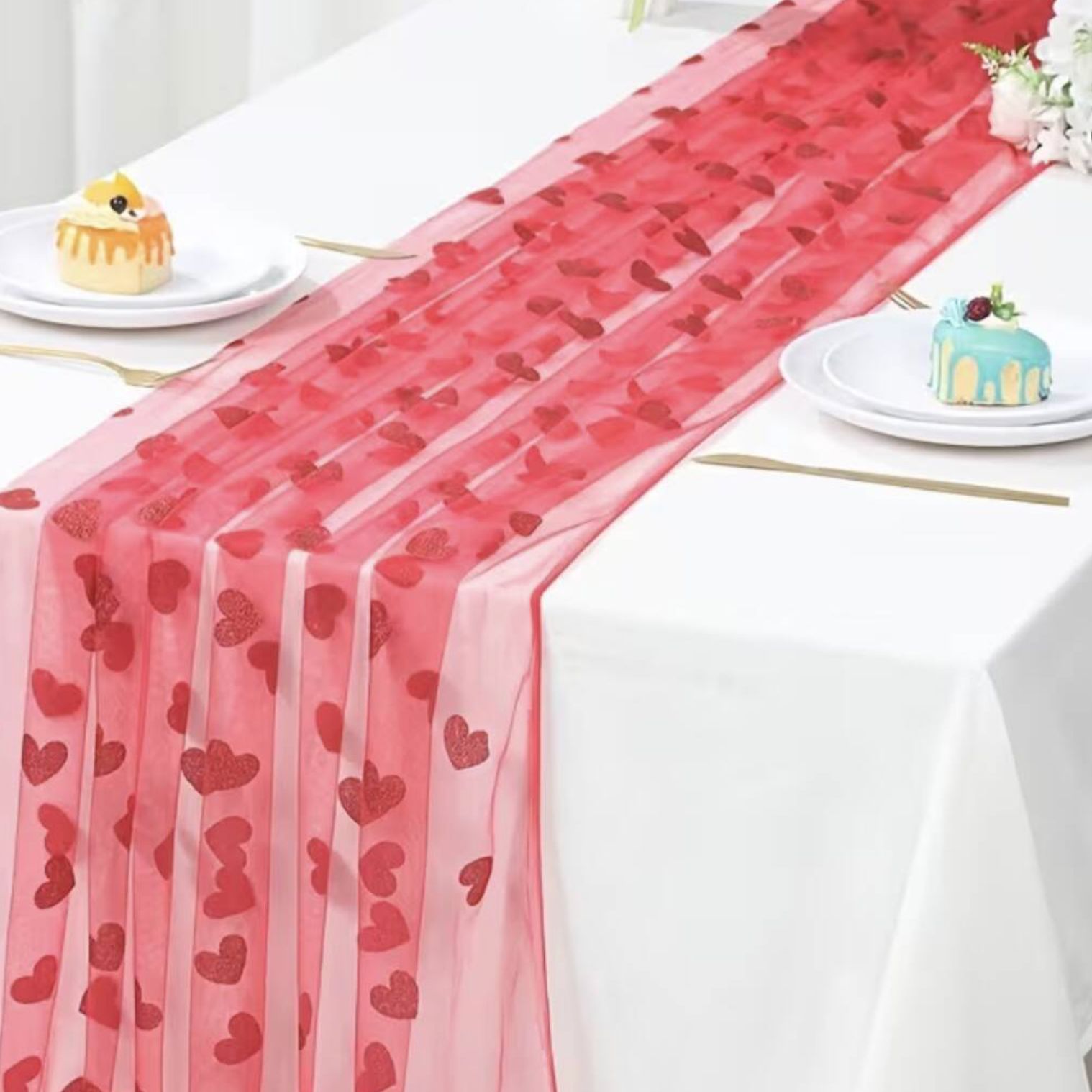 Close up of Embroidered Lace Hearts Table Runner held in a hand showing the sheer organza fabric and glitter embroidered heart detail