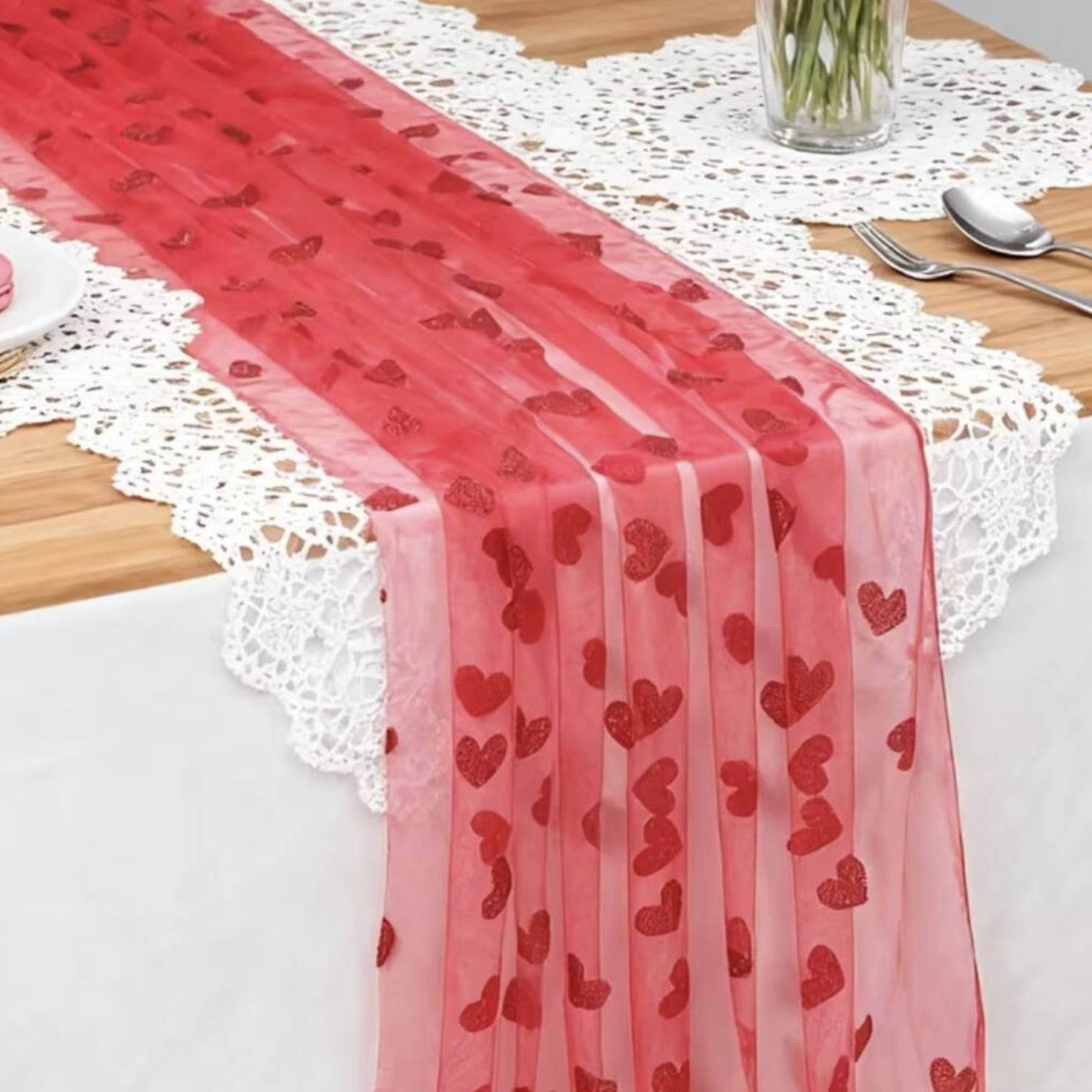 Close up of Embroidered Lace Hearts Table Runner on a white banquet table showing the scattered glitter heart embroidery detail