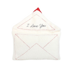Hand lifting the flap of the Love Letter Embroidered Boucle Cushion to reveal the embroidered I Love You message inside